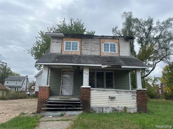 Two-story brick and white siding residential house